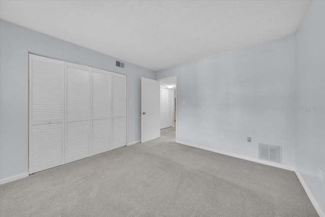 2681 Sabal Springs Cir Unit 204, Clearwater, FL 33761 - unfurnished bedroom with carpet floors and a closet