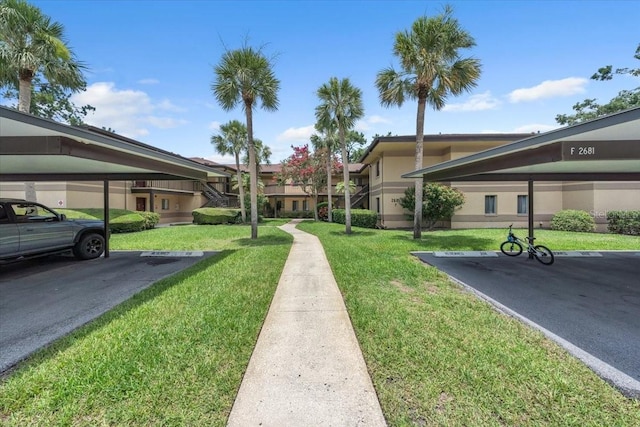 2681 Sabal Springs Cir Unit 204, Clearwater, FL 33761 - surrounding community with covered parking and a yard