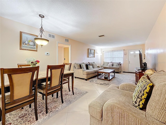5870 38th Ave N Unit 44, Saint Petersburg, FL 33710 - living room with light tile patterned floors and a textured ceiling