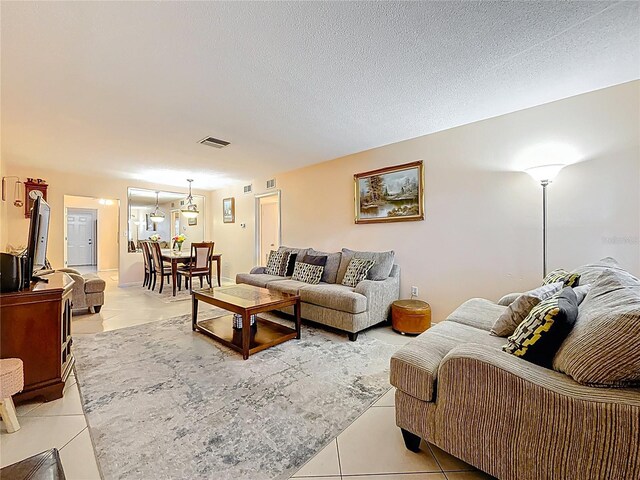 5870 38th Ave N Unit 44, Saint Petersburg, FL 33710 - living room featuring light tile patterned floors and a textured ceiling