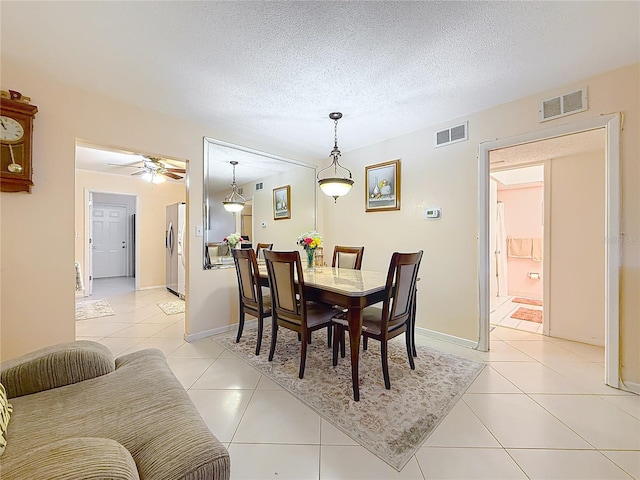 5870 38th Ave N Unit 44, Saint Petersburg, FL 33710 - dining area with light tile patterned flooring, a textured ceiling, and ceiling fan