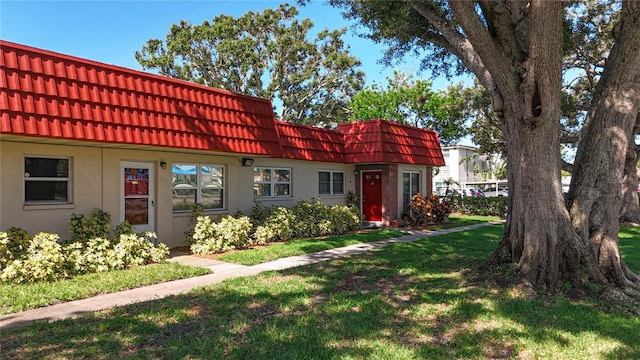 5870 38th Ave N Unit 44, Saint Petersburg, FL 33710 - multi unit property with mansard roof, a tile roof, a front yard, and stucco siding