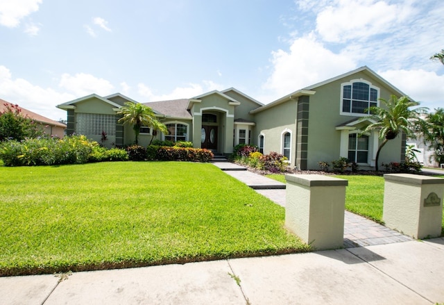 916 Bunker View Dr, Apollo Beach, FL 33572 - view of front of home with stucco siding and a front yard