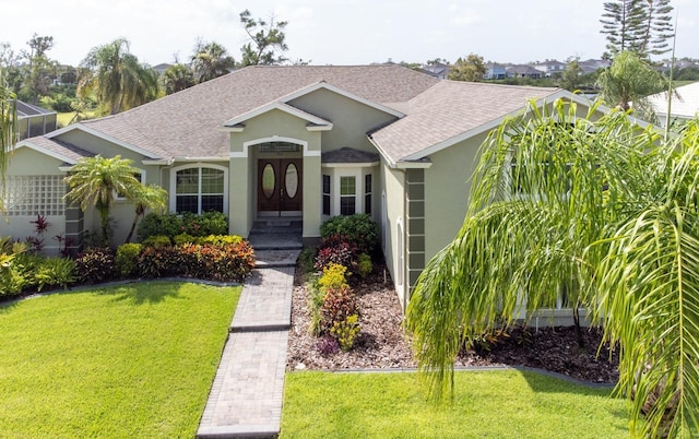 916 Bunker View Dr, Apollo Beach, FL 33572 - ranch-style home with stucco siding, roof with shingles, and a front lawn