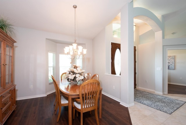 916 Bunker View Dr, Apollo Beach, FL 33572 - dining room with a chandelier, vaulted ceiling, arched walkways, and wood finished floors