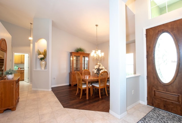 916 Bunker View Dr, Apollo Beach, FL 33572 - foyer with high vaulted ceiling, healthy amount of natural light, a chandelier, and light tile patterned flooring