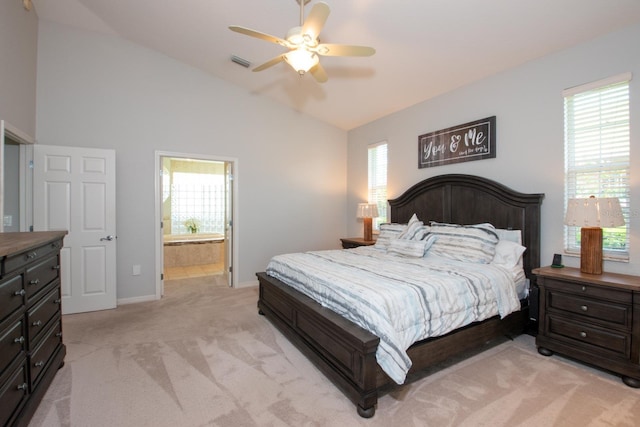 916 Bunker View Dr, Apollo Beach, FL 33572 - bedroom featuring light carpet, vaulted ceiling, multiple windows, connected bathroom, and ceiling fan