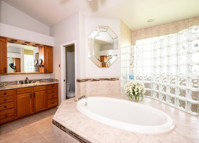 916 Bunker View Dr, Apollo Beach, FL 33572 - full bathroom featuring a bath, vanity, vaulted ceiling, and tile patterned floors