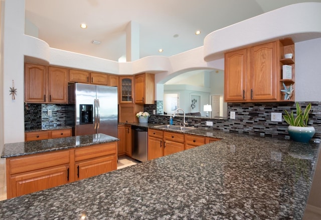 916 Bunker View Dr, Apollo Beach, FL 33572 - kitchen with appliances with stainless steel finishes, tasteful backsplash, dark stone countertops, open shelves, and recessed lighting