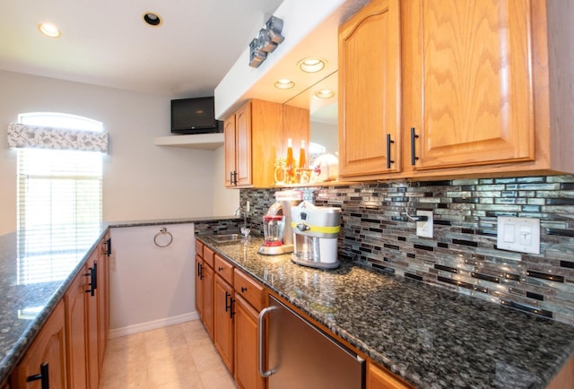 916 Bunker View Dr, Apollo Beach, FL 33572 - kitchen with dark stone countertops, decorative backsplash, light tile patterned floors, and recessed lighting