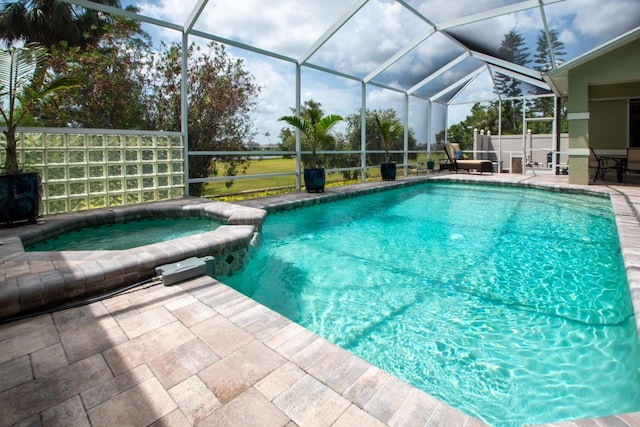916 Bunker View Dr, Apollo Beach, FL 33572 - view of swimming pool with a patio area, glass enclosure, and a pool with connected hot tub