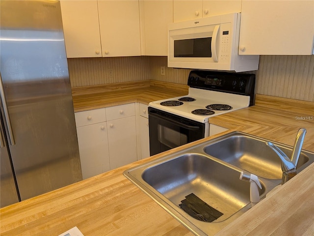 642 Bird Bay Dr E Unit 205, Venice, FL 34285 - kitchen featuring white appliances, wood counters, and white cabinetry