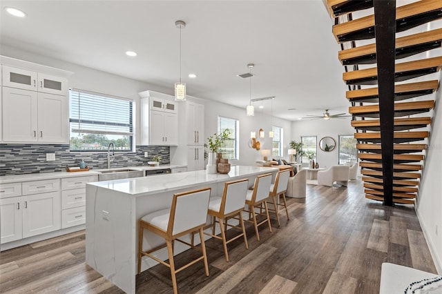 6210 64th Way N, Pinellas Park, FL 33781 - kitchen featuring open floor plan, a kitchen island, decorative backsplash, recessed lighting, and light wood-style flooring