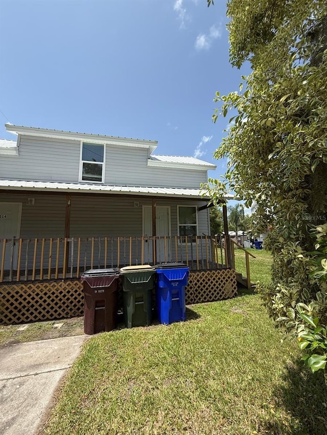 1512 7th St, Saint Cloud, FL 34769 - view of front facade with a front yard and a metal roof