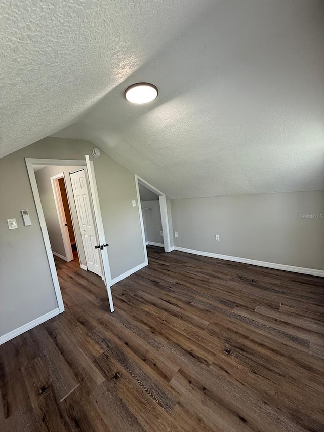 1512 7th St, Saint Cloud, FL 34769 - additional living space with a textured ceiling, dark wood finished floors, and lofted ceiling