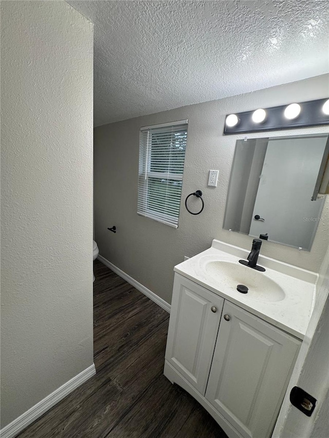 1512 7th St, Saint Cloud, FL 34769 - bathroom with vanity, wood finished floors, a textured ceiling, and a textured wall