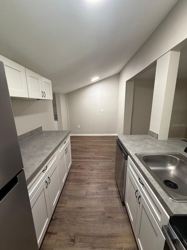1512 7th St, Saint Cloud, FL 34769 - kitchen with appliances with stainless steel finishes, white cabinetry, dark wood-type flooring, and recessed lighting