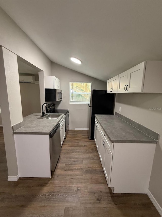 1512 7th St, Saint Cloud, FL 34769 - kitchen with stainless steel appliances, a wall mounted air conditioner, lofted ceiling, and dark wood-type flooring