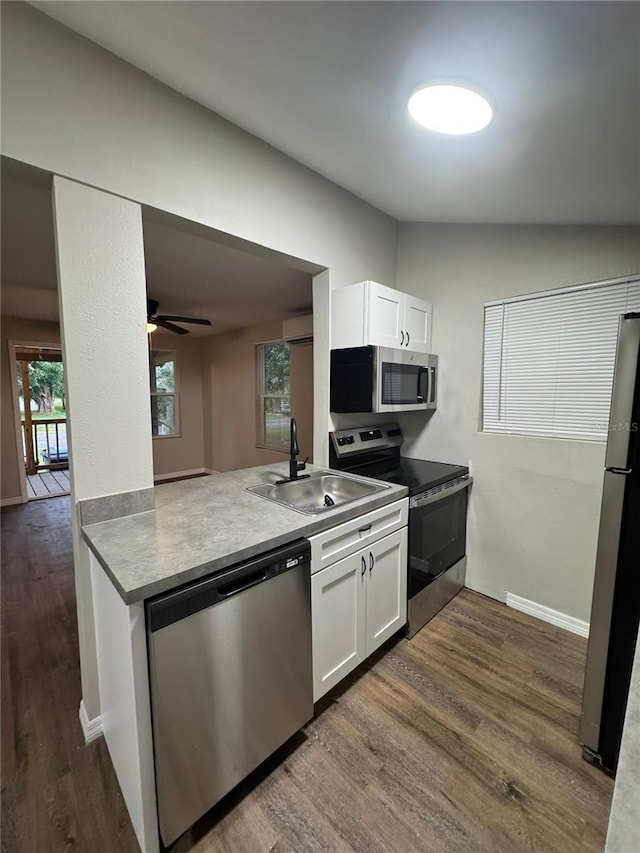 1512 7th St, Saint Cloud, FL 34769 - kitchen featuring appliances with stainless steel finishes, dark wood finished floors, white cabinetry, ceiling fan, and a wall mounted AC