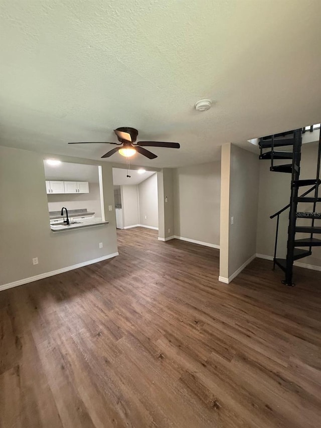 1512 7th St, Saint Cloud, FL 34769 - unfurnished living room with dark wood-type flooring, a ceiling fan, and a textured ceiling