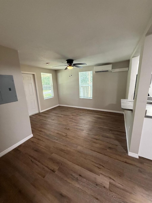 1512 7th St, Saint Cloud, FL 34769 - unfurnished living room featuring a wall unit AC, plenty of natural light, wood finished floors, and ceiling fan