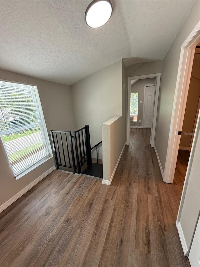 1512 7th St, Saint Cloud, FL 34769 - corridor with an upstairs landing, wood finished floors, and a textured ceiling