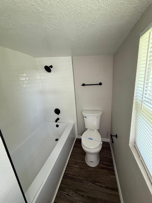 1512 7th St, Saint Cloud, FL 34769 - full bath with wood finished floors, a textured ceiling, and shower / bathtub combination