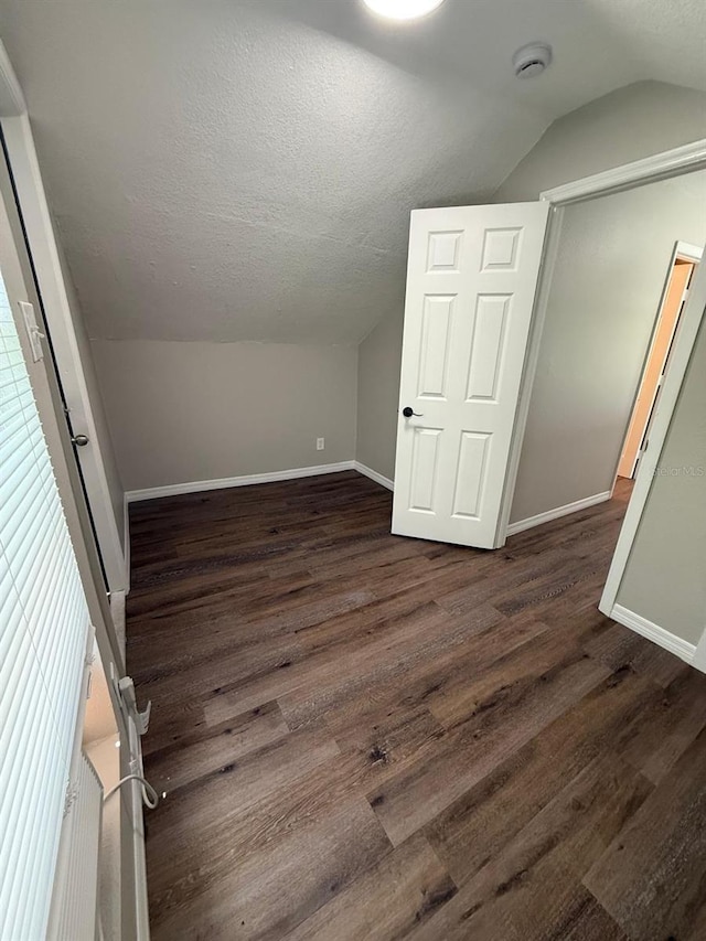 1512 7th St, Saint Cloud, FL 34769 - additional living space featuring vaulted ceiling, wood finished floors, and a textured ceiling