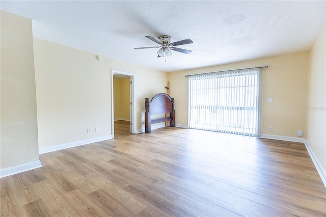 6332 Newtown Cir Unit 32B2, Tampa, FL 33615 - unfurnished room with a ceiling fan, light wood-type flooring, and a textured ceiling
