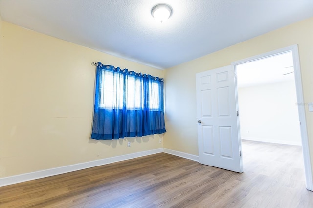 6332 Newtown Cir Unit 32B2, Tampa, FL 33615 - empty room featuring wood finished floors and a textured ceiling