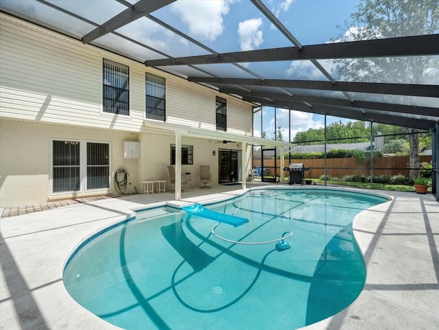 15711 Springmoss Ln, Tampa, FL 33624 - view of pool featuring ceiling fan, a patio area, glass enclosure, and grilling area