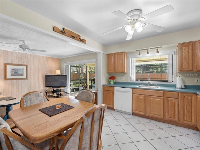 15711 Springmoss Ln, Tampa, FL 33624 - kitchen featuring dishwasher, a ceiling fan, wooden walls, and light tile patterned floors