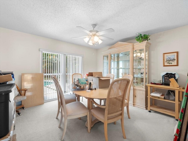 15711 Springmoss Ln, Tampa, FL 33624 - dining room featuring ceiling fan, light colored carpet, and a textured ceiling