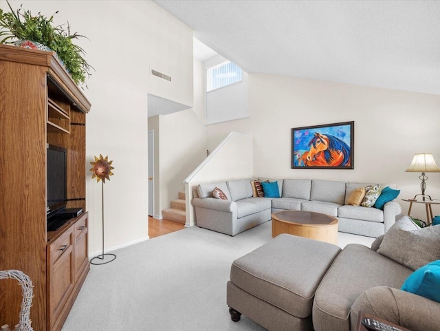 15711 Springmoss Ln, Tampa, FL 33624 - living room with high vaulted ceiling, light colored carpet, and stairway