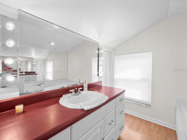 15711 Springmoss Ln, Tampa, FL 33624 - bathroom with lofted ceiling, vanity, and wood finished floors