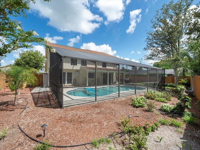 15711 Springmoss Ln, Tampa, FL 33624 - rear view of property featuring a fenced backyard, a lanai, and a patio