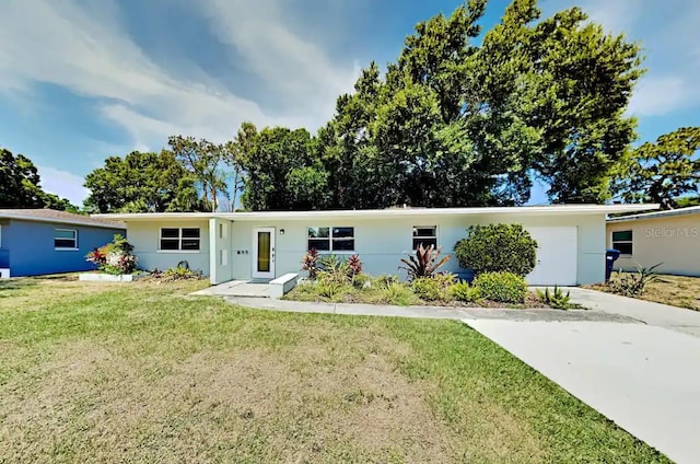 4505 S Clark Ave, Tampa, FL 33611 - ranch-style home featuring a front lawn, stucco siding, and driveway