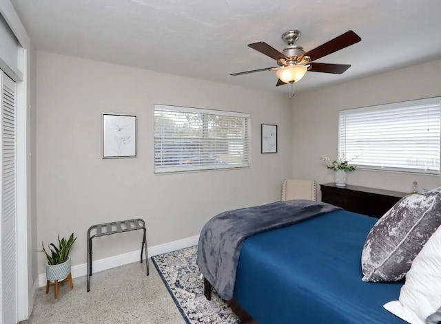 4505 S Clark Ave, Tampa, FL 33611 - bedroom featuring speckled floor, multiple windows, a closet, and a ceiling fan