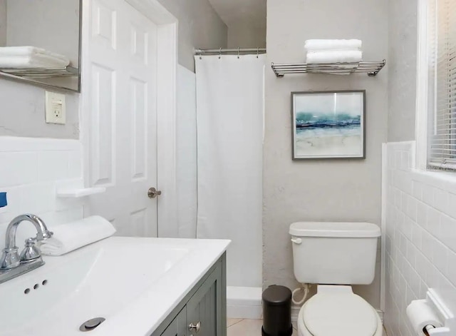 4505 S Clark Ave, Tampa, FL 33611 - bathroom with vanity, a shower with curtain, and tile walls