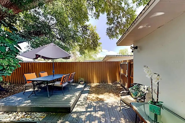4505 S Clark Ave, Tampa, FL 33611 - deck featuring a fenced backyard and outdoor dining space