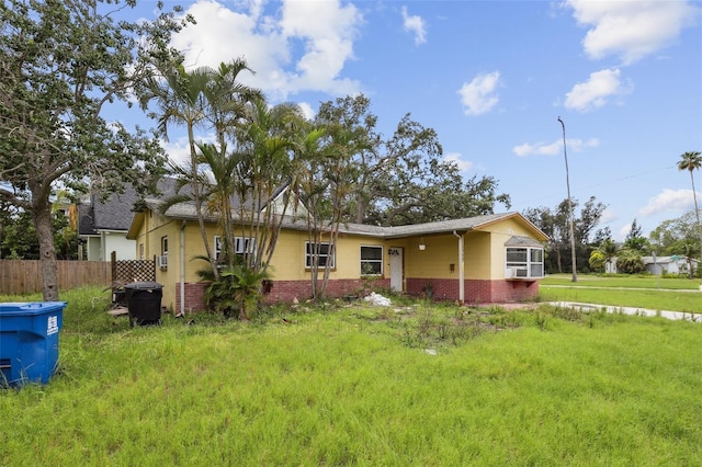 1560 Connecticut Ave NE, Saint Petersburg, FL 33703 - rear view of house featuring brick siding