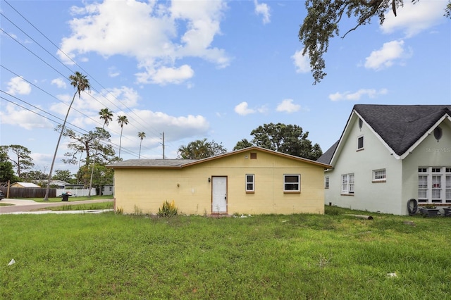 1560 Connecticut Ave NE, Saint Petersburg, FL 33703 - back of property featuring a yard and a shingled roof
