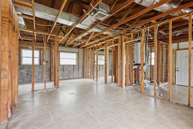 1560 Connecticut Ave NE, Saint Petersburg, FL 33703 - miscellaneous room featuring water heater and light tile patterned flooring