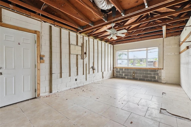 1560 Connecticut Ave NE, Saint Petersburg, FL 33703 - misc room with concrete block wall, cooling unit, and ceiling fan