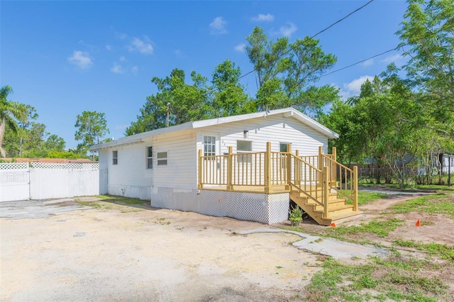 9445 Cardy St, New Port Richey, FL 34654 - view of front of house with a wooden deck
