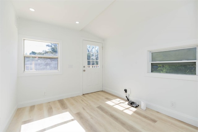 9445 Cardy St, New Port Richey, FL 34654 - empty room featuring wood finished floors, recessed lighting, and vaulted ceiling