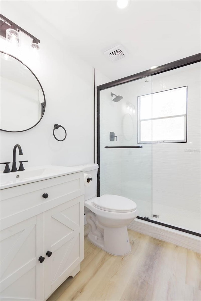 9445 Cardy St, New Port Richey, FL 34654 - full bathroom with vanity, a shower stall, and wood finished floors