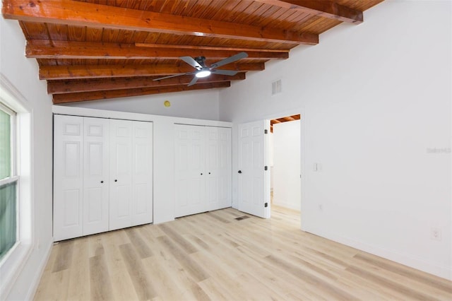 9445 Cardy St, New Port Richey, FL 34654 - unfurnished bedroom with multiple closets, a wood ceiling with exposed beams, light wood-type flooring, and high vaulted ceiling