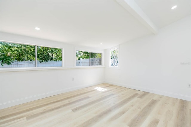 9445 Cardy St, New Port Richey, FL 34654 - spare room with wood finished floors, recessed lighting, and beam ceiling