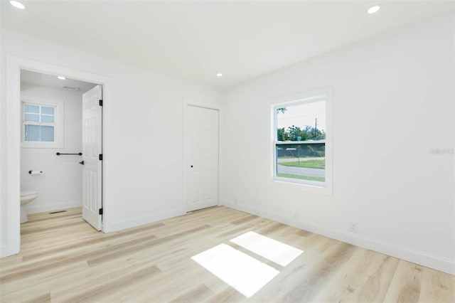 9445 Cardy St, New Port Richey, FL 34654 - unfurnished bedroom with wood finished floors, recessed lighting, and a closet